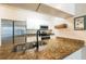 A close-up view of the kitchen featuring a granite countertop and stainless steel appliances at 16431 Enclave Village Dr # 16431, Tampa, FL 33647