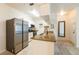 Bright kitchen featuring granite countertops, stainless steel refrigerator, white cabinets, and tile flooring at 16431 Enclave Village Dr # 16431, Tampa, FL 33647