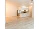 Open living space leading into a kitchen with stainless steel appliances and hardwood-style floors at 16431 Enclave Village Dr # 16431, Tampa, FL 33647