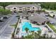 Aerial view of the community pool and clubhouse with ample parking and meticulous landscaping at 16431 Enclave Village Dr # 16431, Tampa, FL 33647