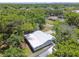 An aerial view showcasing the home's roof, surrounded by lush greenery and the neighborhood at 1817 West Dr, Clearwater, FL 33755