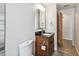 Bathroom featuring a modern dark vanity with a granite top, tile floor, and updated fixtures at 1817 West Dr, Clearwater, FL 33755