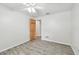 A bright bedroom features an open wood door, neutral walls, tile flooring, and a ceiling fan at 1817 West Dr, Clearwater, FL 33755