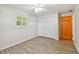 Cozy bedroom featuring wood-look floors, a ceiling fan, a closet, and natural light from a window at 1817 West Dr, Clearwater, FL 33755