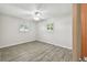 This is a bright bedroom with two windows, a ceiling fan, and wood look tile flooring at 1817 West Dr, Clearwater, FL 33755