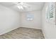 A clean and well lit bedroom with tile flooring, a window with shutters and neutral walls at 1817 West Dr, Clearwater, FL 33755