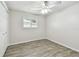 Cozy bedroom with new floors, a ceiling fan, a window with blinds, and a closet at 1817 West Dr, Clearwater, FL 33755