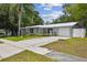 Charming single-story home featuring a well-manicured lawn, mature landscaping, and a paved driveway at 1817 West Dr, Clearwater, FL 33755