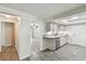 Galley kitchen shows gray cabinets, solid surface countertops, and wood look tile flooring at 1817 West Dr, Clearwater, FL 33755