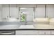 Kitchen has gray cabinets, solid surface countertops and a pass-through to another room at 1817 West Dr, Clearwater, FL 33755