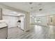 Open-concept kitchen featuring white appliances, granite countertops, and seamless flow into the living area at 1817 West Dr, Clearwater, FL 33755