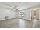 Bright living room featuring wood-look tile flooring, neutral walls, updated fixtures, and a large window at 1817 West Dr, Clearwater, FL 33755