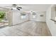Bright living room with tile flooring, ceiling fans, and sliding door to backyard at 1817 West Dr, Clearwater, FL 33755