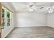 Spacious living room with new floors, ceiling fans, and large window offering ample natural light at 1817 West Dr, Clearwater, FL 33755