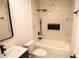 Modern bathroom featuring white marble-look tile, black fixtures, and a shower-tub combination at 1820 Douglas Ave, Clearwater, FL 33755
