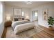 Serene bedroom with neutral tones, soft lighting, stylish decor, and a comfortable queen-sized bed at 1820 Douglas Ave, Clearwater, FL 33755