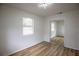 Sunlit bedroom featuring new flooring, closet with mirrored doors, and freshly painted walls at 1820 Douglas Ave, Clearwater, FL 33755