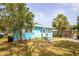 Turquoise home featuring a manicured front yard and welcoming entrance with a modern paint scheme at 1820 Douglas Ave, Clearwater, FL 33755
