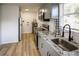 Well-lit kitchen with stainless steel appliances, light gray cabinetry, and sleek countertops at 1820 Douglas Ave, Clearwater, FL 33755