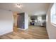 Open-concept living area with wood floors flows into a modern kitchen with stainless steel appliances at 1820 Douglas Ave, Clearwater, FL 33755