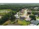 Aerial view of home with a pool and a private backyard surrounded by lush greenery near a serene lake at 1949 Tampa Bay Dr, Wesley Chapel, FL 33543