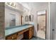 Bathroom with wood cabinets, long vanity with dressing table, large mirror, and toilet in a separate area at 1949 Tampa Bay Dr, Wesley Chapel, FL 33543