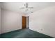 An empty bedroom with a ceiling fan, and a doorway to another room at 1949 Tampa Bay Dr, Wesley Chapel, FL 33543
