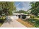 This lovely home features a long driveway, a manicured lawn, and lovely landscaping at 1949 Tampa Bay Dr, Wesley Chapel, FL 33543