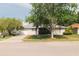 A view of this beautiful single-story home displaying mature trees that add to the home's curb appeal at 1949 Tampa Bay Dr, Wesley Chapel, FL 33543