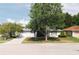 This single-story home is surrounded by mature shade trees at 1949 Tampa Bay Dr, Wesley Chapel, FL 33543