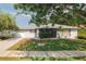 Charming single-story home featuring a well-maintained lawn and a welcoming, covered entryway at 1949 Tampa Bay Dr, Wesley Chapel, FL 33543