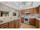 Bright kitchen with white countertops, oak cabinetry, and a view of the living area at 1949 Tampa Bay Dr, Wesley Chapel, FL 33543