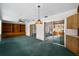 Large living room with cabinets, built-in shelving and sliding glass doors at 1949 Tampa Bay Dr, Wesley Chapel, FL 33543