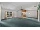 Open-concept living room features a front door, a window and flows into the kitchen at 1949 Tampa Bay Dr, Wesley Chapel, FL 33543