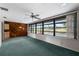 Features of the living room include a wood paneled wall, a ceiling fan, and windows at 1949 Tampa Bay Dr, Wesley Chapel, FL 33543