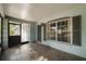 This beautiful porch has grey trim, tiled floors, and large windows at 1949 Tampa Bay Dr, Wesley Chapel, FL 33543