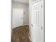 Hallway features wood-look tile and white paneled doors at 19664 Ship Wheel Way, Land O Lakes, FL 34638
