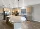 Modern kitchen with granite countertops, stainless steel appliances, and a large island with pendant lighting at 19664 Ship Wheel Way, Land O Lakes, FL 34638