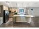Spacious kitchen with stainless steel appliances, granite countertops and a central island with bar seating at 19664 Ship Wheel Way, Land O Lakes, FL 34638