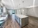 Modern kitchen featuring a granite island and stainless steel appliances, seamlessly connected to the living and dining areas at 19664 Ship Wheel Way, Land O Lakes, FL 34638