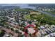 Aerial view showcases the property's location near a pond, baseball park and tennis courts at 2031 Dover Ct, Oldsmar, FL 34677