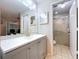 Updated bathroom features modern vanity with white countertop, shower, and neutral color palette at 2031 Dover Ct, Oldsmar, FL 34677