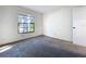 This bedroom features neutral carpeting and natural light from a window at 2031 Dover Ct, Oldsmar, FL 34677