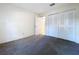 This bedroom features neutral carpeting and large closet at 2031 Dover Ct, Oldsmar, FL 34677