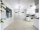 Inviting dining area with tiled floors, a modern pendant light, and ample natural light at 2031 Dover Ct, Oldsmar, FL 34677