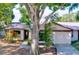 Charming single-story home featuring a well-manicured lawn, mature trees, and an attached garage at 2031 Dover Ct, Oldsmar, FL 34677