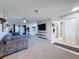 Spacious living room featuring neutral-toned walls, large windows, and a comfortable sofa at 2031 Dover Ct, Oldsmar, FL 34677