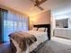 Comfortable main bedroom with a ceiling fan, cozy bedding, and access to the en-suite bathroom at 2031 Dover Ct, Oldsmar, FL 34677