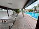 Poolside area with covered picnic tables and relaxing atmosphere at 2031 Dover Ct, Oldsmar, FL 34677