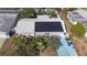 Charming home with solar panels, landscaped yard, and a vibrant blue driveway at 2066 High Ridge Dr, Clearwater, FL 33763
